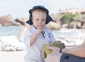 Toddler Boy Drinks from a Coconut on the Beach in Mexico