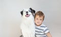 Toddler boy embracing australian shepherd dog indoor. Best friends consept. Royalty Free Stock Photo