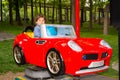Toddler boy having fun in a car in park Royalty Free Stock Photo