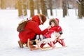 Toddler boy and his mother having fun in winter park Royalty Free Stock Photo