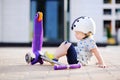 Toddler boy learning to ride scooter Royalty Free Stock Photo