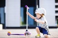 Toddler boy learning to ride scooter Royalty Free Stock Photo