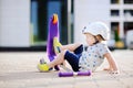 Toddler boy learning to ride scooter Royalty Free Stock Photo