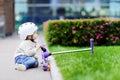 Toddler boy learning to ride scooter Royalty Free Stock Photo