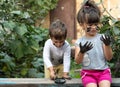 Toddler Boy and little girl - dirty from playing in the mud. Royalty Free Stock Photo