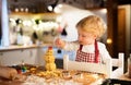 Toddler boy making gingerbread cookies at home. Royalty Free Stock Photo