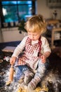 Toddler boy making gingerbread cookies at home. Royalty Free Stock Photo