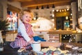 Toddler boy making gingerbread cookies at home. Royalty Free Stock Photo