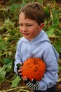 Toddler Boy with an orange pumpkin