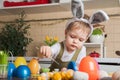 Toddler boy painting Easter egg close-up. Easter traditions and entertainment with children at home