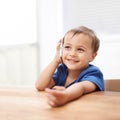 Toddler, boy and phonecall at home, happiness and communication with technology. Table, calling and conversation for Royalty Free Stock Photo