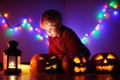 Toddler boy playing with halloween pumpkins indoors Royalty Free Stock Photo