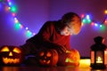 Toddler boy playing with halloween pumpkins indoors Royalty Free Stock Photo