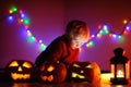 Toddler boy playing with halloween pumpkins indoors Royalty Free Stock Photo