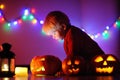Toddler boy playing with halloween pumpkins indoors Royalty Free Stock Photo