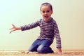 Toddler boy is playing in the house on the floor. A kid boy playing toy blocks inside his house. Happy little boy. Smiling child Royalty Free Stock Photo