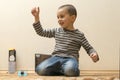 Toddler boy is playing in the house on the floor. A kid boy playing toy blocks inside his house. Happy little boy. Smiling child Royalty Free Stock Photo