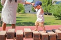 Toddler boy playing on playground - walking on unstable wooden bridge