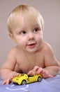 Toddler boy playing with a toy car