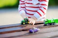 Toddler boy playing with toy cars close up