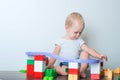 Toddler boy plays with constructor, cars, blocks close-up. Educational toys for preschool children