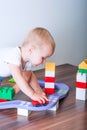 Toddler boy plays with constructor, cars, blocks close-up. Educational toys for preschool children