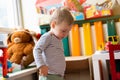 Toddler boy plays with toys in the children`s room. Educational toys for young children. Child one and a half years - two years. Royalty Free Stock Photo