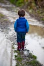 Toddler boy in puddle Royalty Free Stock Photo