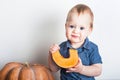 Toddler boy with pumpkin close-up. First baby food, autumn harvest.. Royalty Free Stock Photo