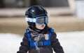 Toddler Boy Ready to Ski with all Safety Gear. Helmet & Harness. Royalty Free Stock Photo
