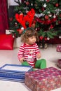 Toddler boy with reindeer ears looking away