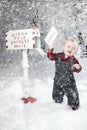 Toddler boy with Reindeer in snow Royalty Free Stock Photo