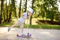 Toddler boy in safety helmet learning to ride scooter Royalty Free Stock Photo