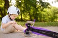 Toddler boy in safety helmet learning to ride scooter Royalty Free Stock Photo