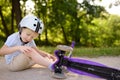 Toddler boy in safety helmet learning to ride scooter Royalty Free Stock Photo