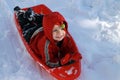 Toddler boy sledding in the snow