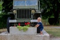 Toddler boy, standing in front of old military autentic jeep car Royalty Free Stock Photo