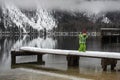 Toddler boy standing on snowy pier