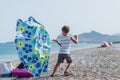 Toddler boy standing on windy beach