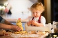 Toddler boy making gingerbread cookies at home. Royalty Free Stock Photo