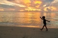 Toddler boy walking on beach at sunset Royalty Free Stock Photo