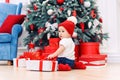 Toddler boy weared in festive clothes playing with christmas gift box. Concept of Christmas and New Year holidays. Royalty Free Stock Photo