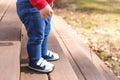 Toddler boy wearing sneakers outside