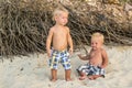 Toddler Boys Sitting on the beach Royalty Free Stock Photo