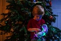 Toddler broken hand in cast illuminated by garland