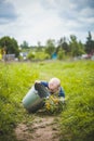 Toddler with a bucket with a bouquet of flowers