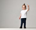 Toddler child baby girl kid standing in white free text space t-shirt pointing finger up