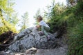 Toddler child climbing the rock on a hiking trail Royalty Free Stock Photo