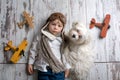 Toddler child and dog, boy and puppy playing together at home Royalty Free Stock Photo