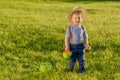 Toddler child outdoors. One year old baby boy wearing straw hat using watering can Royalty Free Stock Photo
